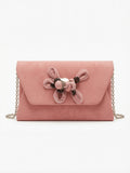 Pink velvet clutch with floral decor
