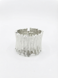 Wide rigid cuff bracelet.