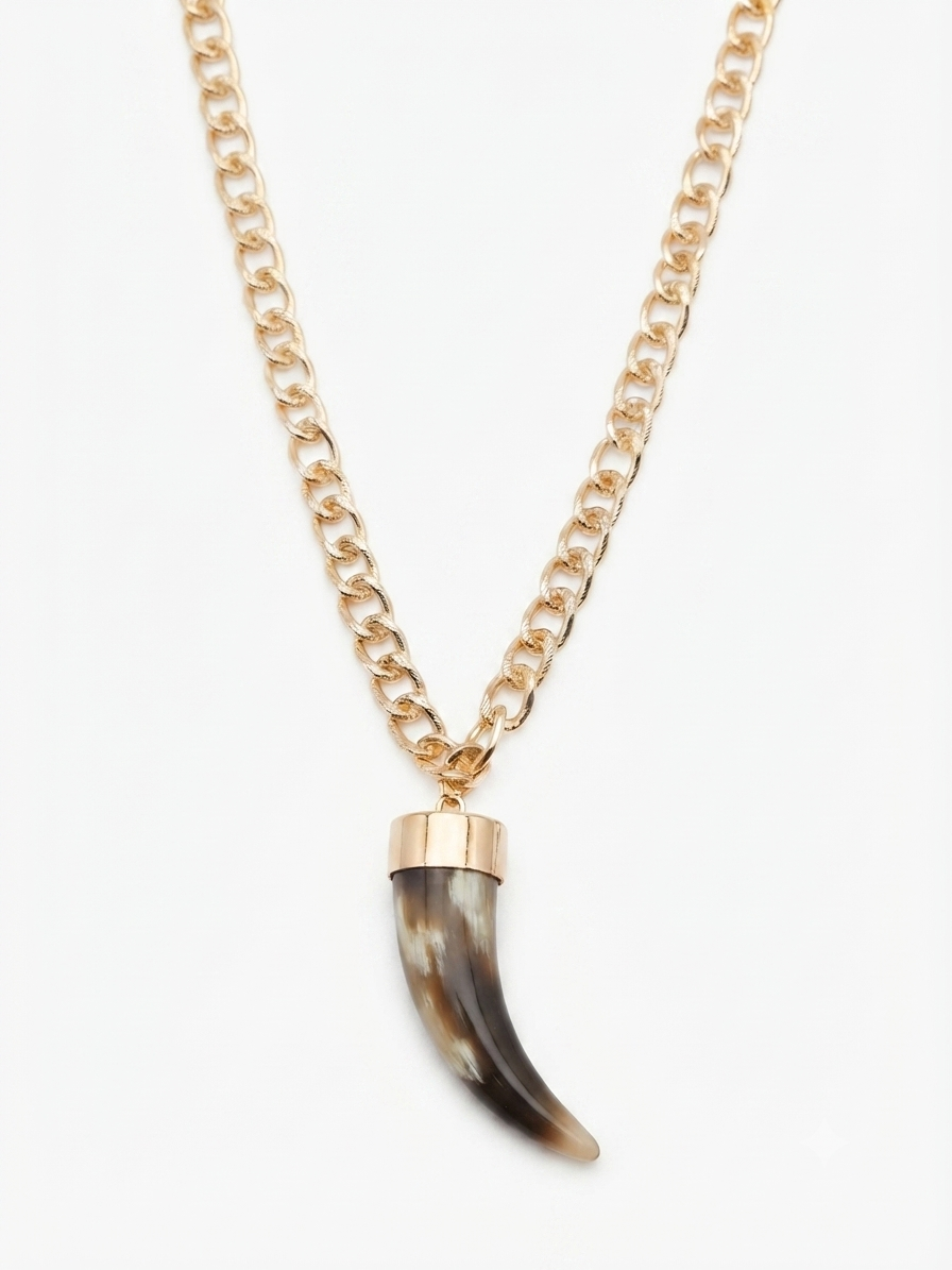 Gold-toned necklace with a chunky fang pendant